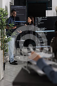 Diverse team of software programmers analyzing html code