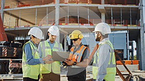 Diverse Team of Specialists Use Laptop Computer on Construction Site. Real Estate Building Project