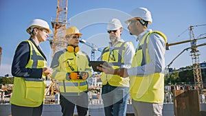 Diverse Team of Specialists Use Tablet Computer on Construction Site. Real Estate Building Project