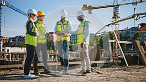 Diverse Team of Specialists Use Tablet Computer on Construction Site. Real Estate Building Project