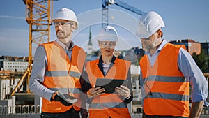 Diverse Team of Specialists Use Tablet Computer on Construction Site. Real Estate Building Project