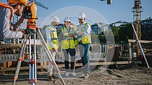 Diverse Team of Specialists Use Tablet Computer on Construction Site. Real Estate Building Project