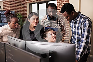 Diverse team of system engineers analyzing html script