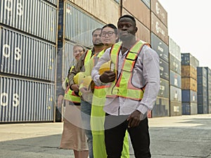 Diverse team of workers standing in front of containers