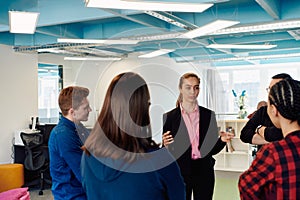 A diverse team of young business people exchanging ideas in a modern startup office