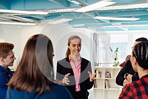 A diverse team of young business people exchanging ideas in a modern startup office