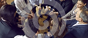 Diverse team of young and mature people sitting in circle at corporate or business meeting