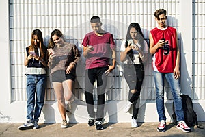 Diverse teenagers with their mobile phones
