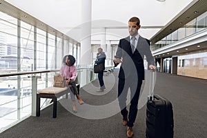 Diverse travelling business people in modern corridor