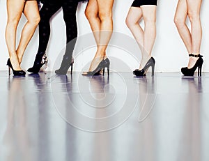 Diverse type pair of woman legs in hight heels black shoes isolated on white background and floor, diversity people