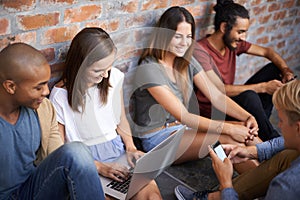 Diverse, university students and studying in hallway, talking and socialising on campus. Technology, laptop and teamwork