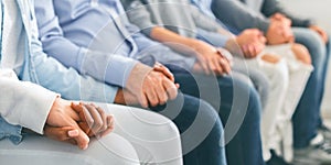Diverse Unrecognizable People Holding Hands, Sitting In A Row Indoors