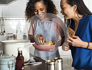 Diverse women cooking in the kitchen together