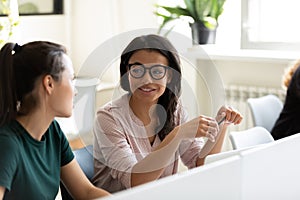 Diverse women employee talk brainstorm at workplace