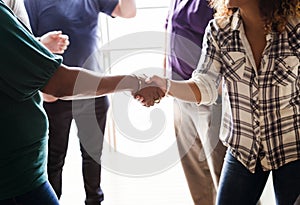 Diverse women shaking hands together