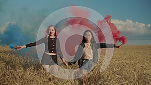 Diverse women walking with smoke bombs across field