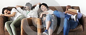 Diverse workers taking rest on couch