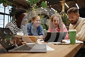 Diverse Young Business Team Reviewing Data During Meeting