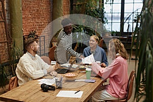 Diverse Young Business Team at Table in Office