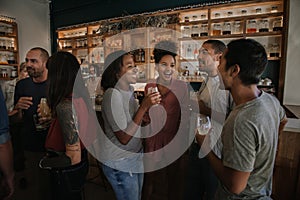 Diverse young friends enjoying an evening in a pub together