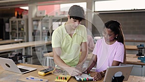 Diverse young high school students learning in science robotics electronic class