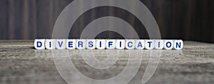 Diversification boggle word cubes on dark background photo