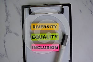 Diversity, Equality, Inclusion write on sticky notes isolated on Wooden Table