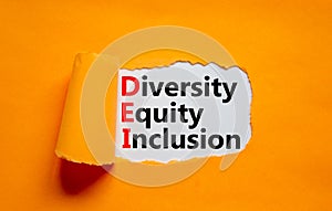 Diversity, equity, inclusion DEI symbol. Words DEI, diversity, equity, inclusion appearing behind torn orange paper. Orange