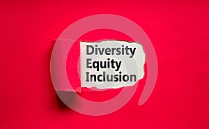 Diversity, equity, inclusion DEI symbol. Words DEI, diversity, equity, inclusion appearing behind torn pink paper. Pink background
