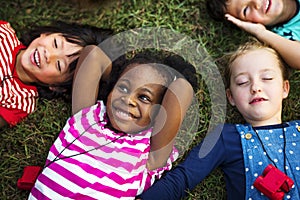 Diversity Group Of Kids Lying on Grass photo