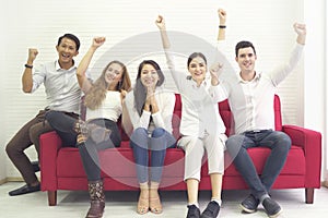 Diversity group of people community friends having fun and laughing happy together, sitting on red sofa, cheer game togetherness