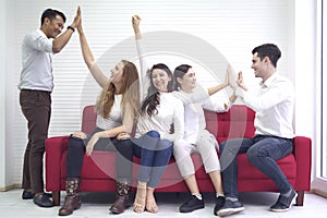 Diversity group of people community friends having fun and laughing happy together, sitting on red sofa, cheer game togetherness