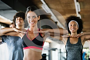 Diversity group of people training in a gym. Trainer and sportive persons exercising