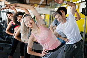 Diversity group of people training in a gym. Trainer and sportive persons exercising