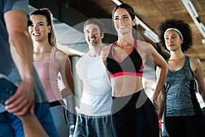 Diversity group of people training in a gym. Trainer and sportive persons exercising