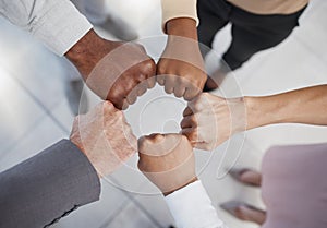 Diversity, hands and team fist above in support, trust and unity for collaboration, agreement or meeting at the office