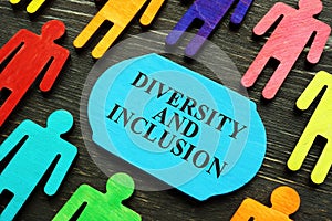 Diversity and inclusion phrase and colored figurines.