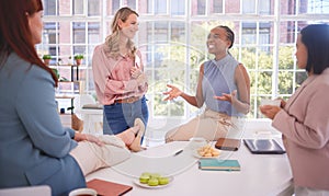 Diversity, lunch and business women relax in an office building talking, gossip or share news after meeting. Team