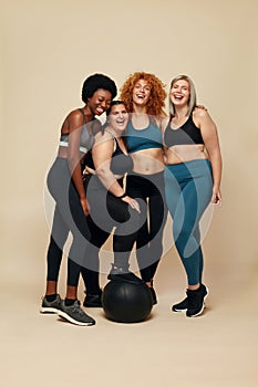 Diversity Models. Different Race And Size Women. Smiling International Friends In Sportswear Looking At Camera.