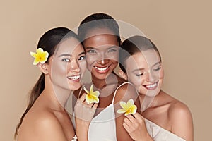 Diversity. Natural Beauty Portrait. Multi-Ethnic Women With Tropical Flowers Standing Together.