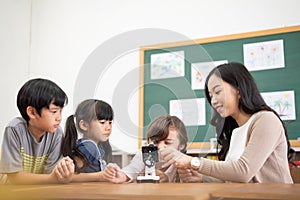 Diversity School kids looking into microscope