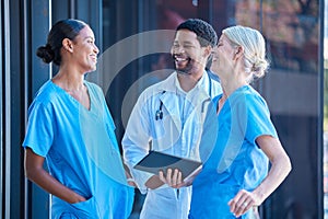 Diversity, teamwork and healthcare, a team of doctors talking and laughing outside a hospital. A happy black doctor and