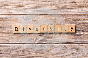 Diversity word written on wood block. Diversity text on wooden table for your desing, concept