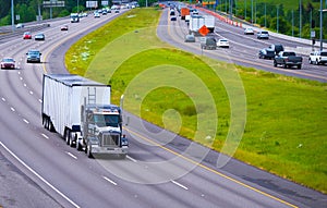 Divided Highway Curve large semi truck with bulk trailer