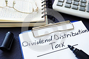 Dividend Distribution Tax DDT written on the sheet of paper.