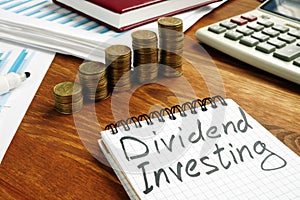 Dividend Investing sign and stacks of money photo