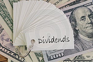 Dividends, return or earning that pay from stock or mutual fund investing concept, lot of paper notes with handwriting word photo