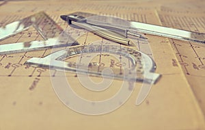And divider compass. Construction and electrotechnology concept. Engineering tools. Circuit diagram on background. Retro