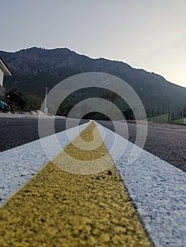 The dividing line on the asphalt is yellow and white