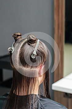 Dividing woman`s hair in sections